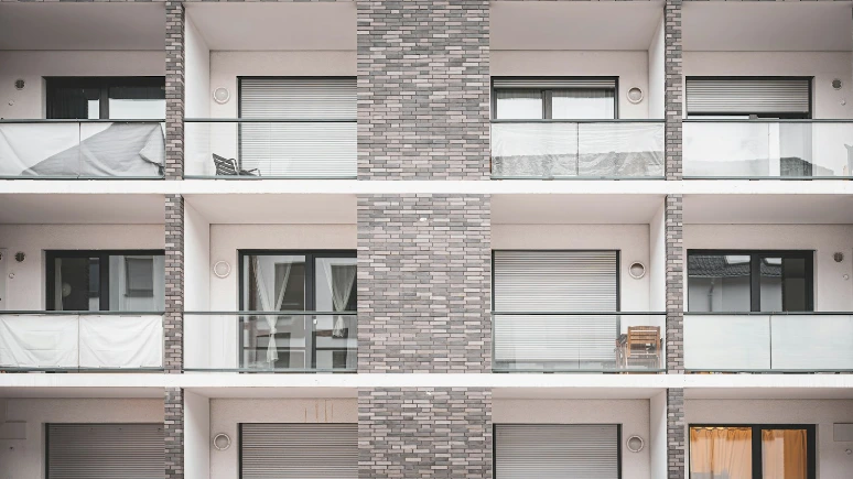 a person walking past a tall brick building